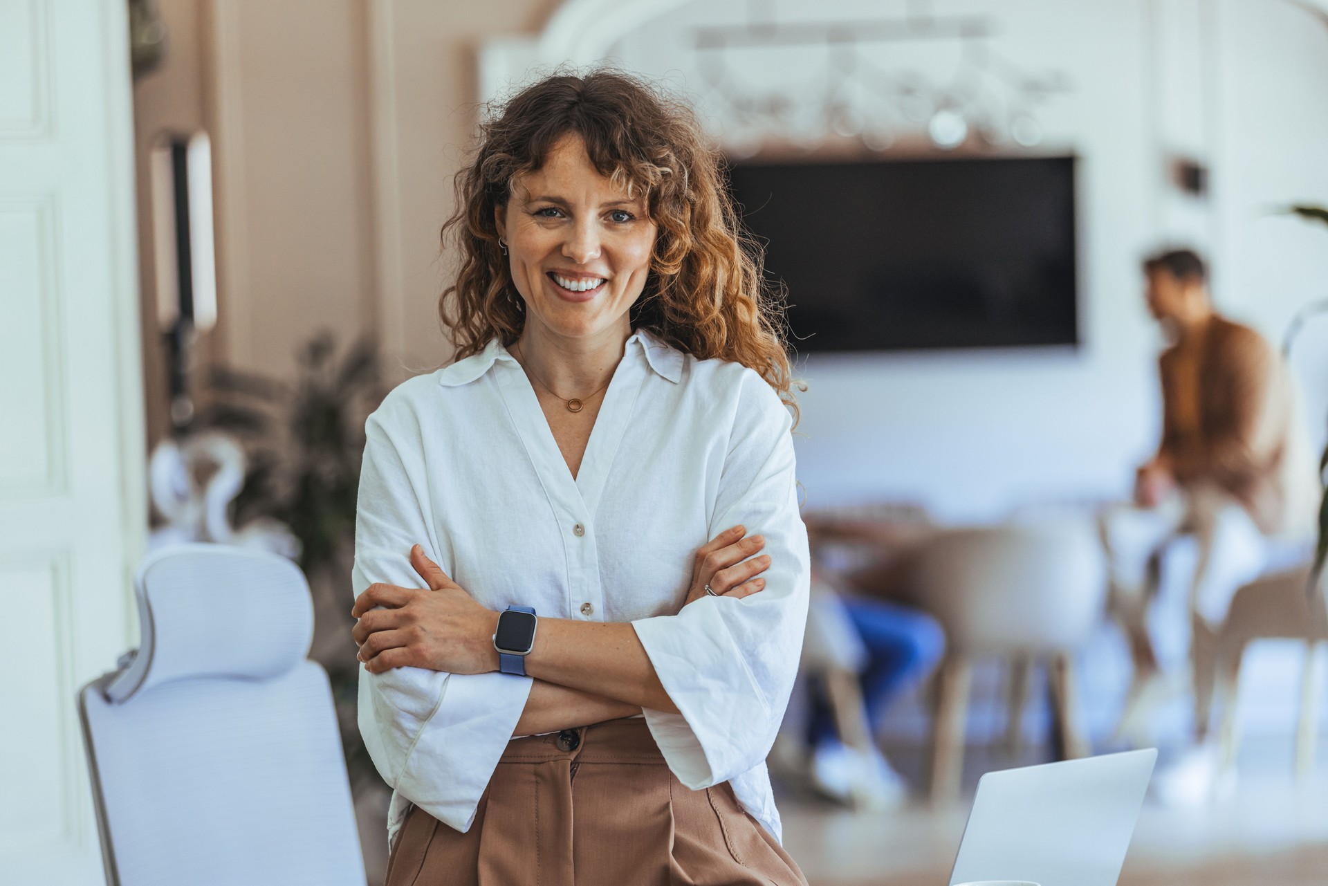Confident Woman Standing in a Casual Modern Office Environment